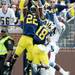 Michigan safety Jarrod Wilson and defensive back Blake Countess reach over Central Michigan wide receiver Titus Davis as they attempt to intercept a pass in the end zone during the first half at Michigan Stadium on Saturday, August 31, 2013. Melanie Maxwell | AnnArbor.com